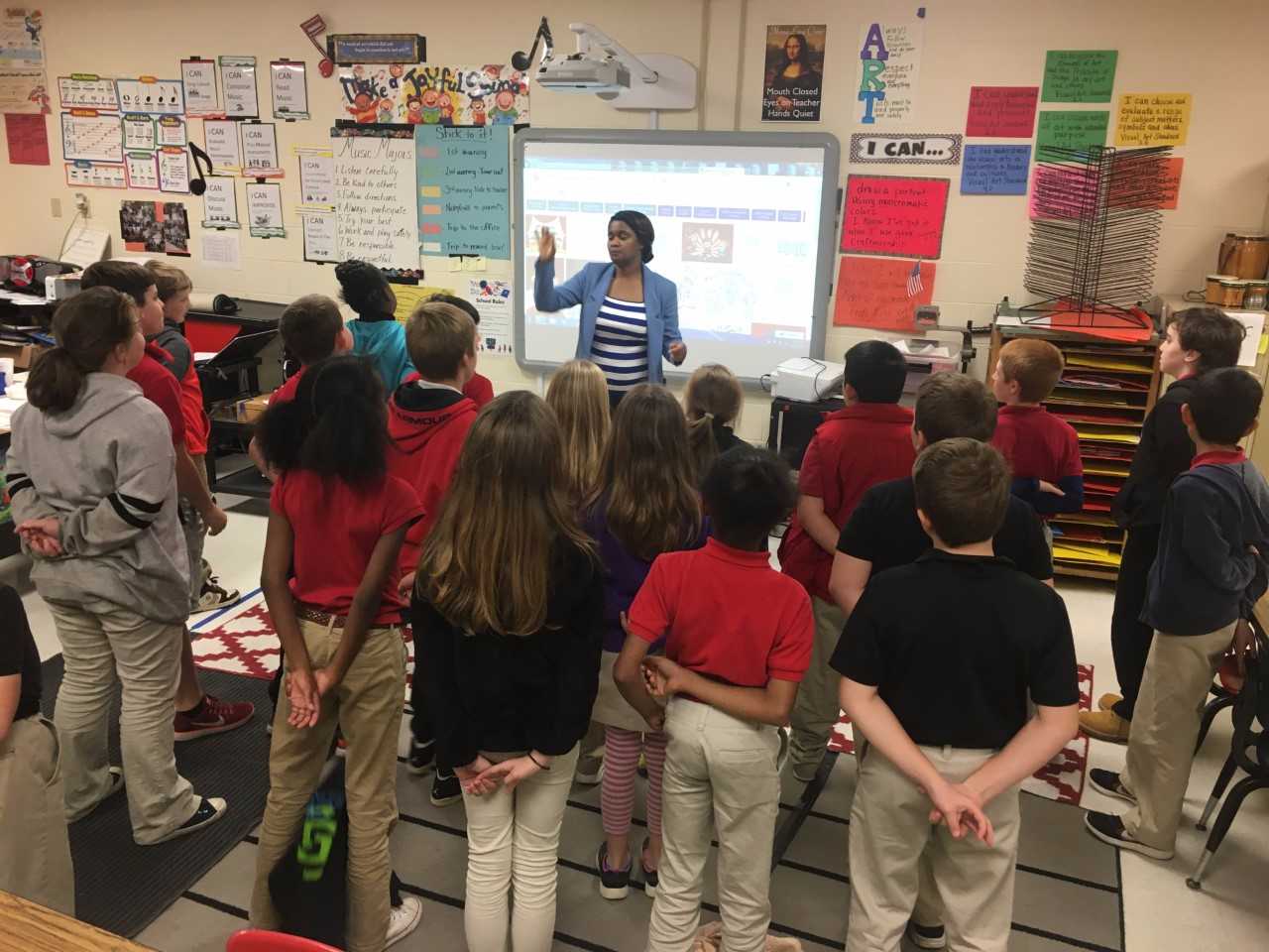 Sheila Houston, music teacher, leads a group of students in song at South Elementary
