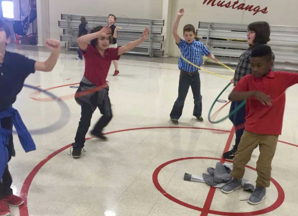 Students at South Elementary School hula hoop during physical education class