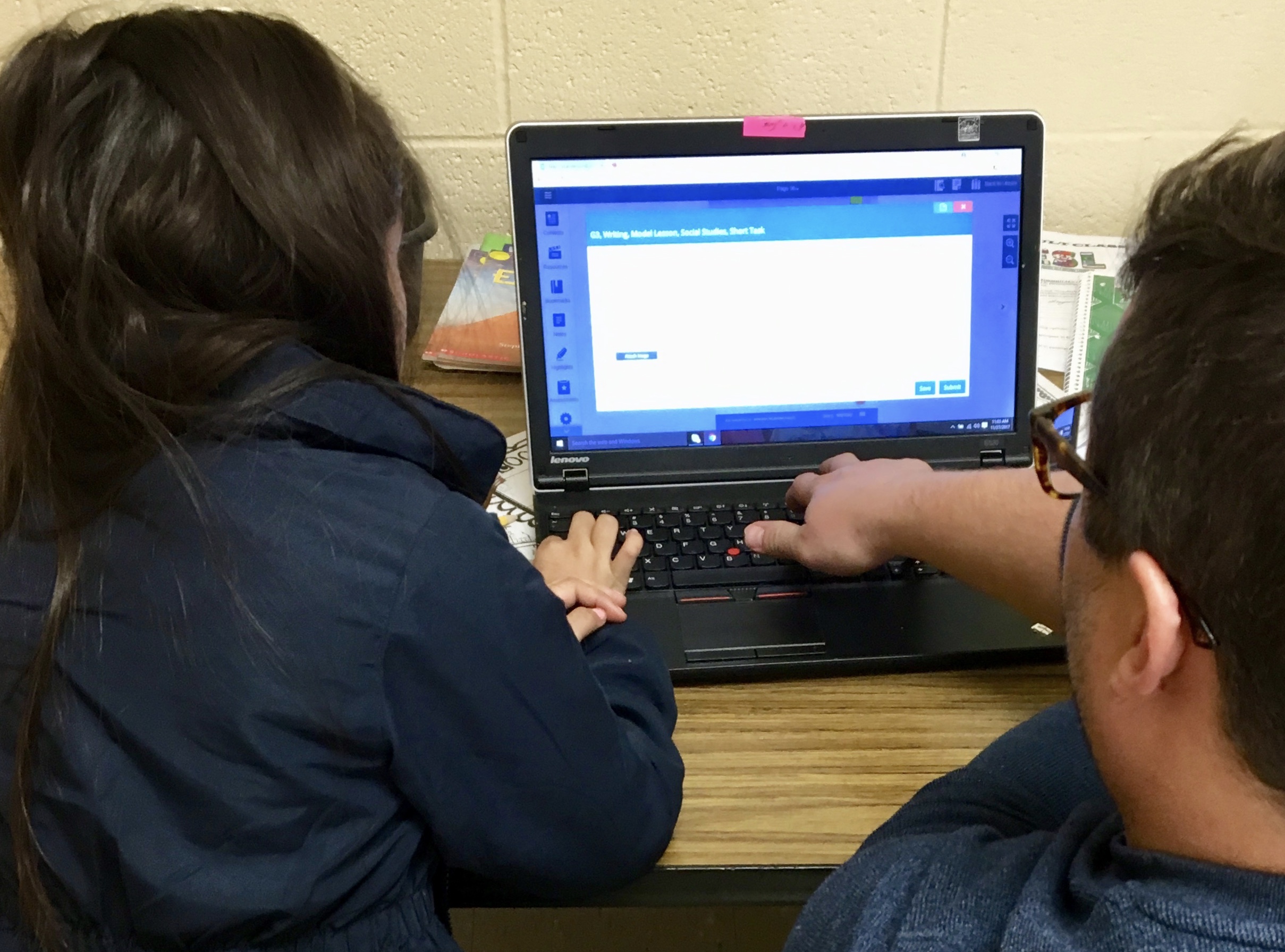 ESL Teacher Brett Anderson works with a student at East Elementary.